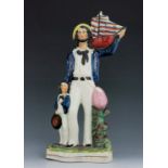A Staffordshire figure of a ‘Sailor’, circa 1855, modelled standing with a boy to his right, holding