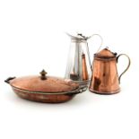 W A S Benson, two Arts and Crafts copper and silver plated jugs and a cast iron entree dish