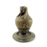 An Egyptian revival bronze tobacco jar, urn form with integrated base, the lid in the form of an