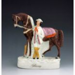 A Staffordshire figure of Solomon Rarey, circa 1860, modelled standing next to his horse Cruiser, po