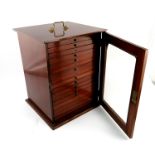 An Edwardian mahogany coin collectors' cabinet, circa 1910, brass swing handle to the cover,