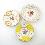 Three early 20th century Meissen floral decorated and relief moulded plates