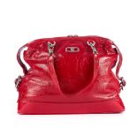 Celine, a red patent leather handbag