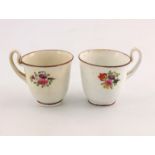 Two relief moulded and painted porcelain tea cups, probably Swansea