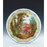 A large opaque glass charger, late 19th Century, possibly Murano, painted with Fragonard's La