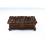 A late 19th Century Cantonese wooden table casket, carved throughout with figures and pagodas in