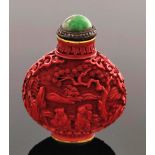 A Chinese cinnabar lacquer snuff bottle, of shouldered form, carved in relief with figures and