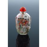 A Chinese clear glass snuff bottle, moulded beast mask shoulders, internally painted with Geishas