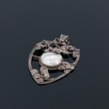 An Arts and Crafts silver and mother of pearl pendant