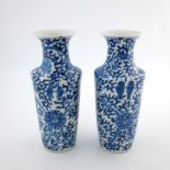 A pair of Chinese blue and white baluster vases, early 20th Century, flared openings, painted with