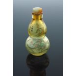 A Chinese double gourd clear glass snuff bottle, internally painted with dragons amongst clouds