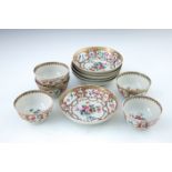 A set of six 18th Century Chinese tea bowls and saucers, decorated with gilt cartouche panels