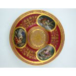 A late 19th Century Vienna porcelain circular stand, raised centre, painted with three named