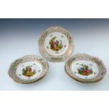 A set of six Potschappel porcelain cabinet plates, decorated with Watteau scenes, reticulated and