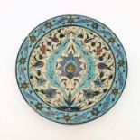 A traditional Iznik design tin glazed earthenware plate, shallow well, predominantly blue decoration