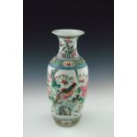 A 19th Century Chinese baluster vase, famille rose decorated in enamels with scenes of exotic