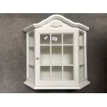 A white painted wall hanging display cabinet