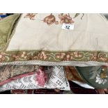 A collection of tablecloth linen, saddle-bags, cus