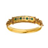 A late 19th century 9ct gold emerald and diamond hinged bangle bracelet