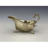 A large George V silver sauce boat, William Hutton, Sheffield 1926, helmet form with beaded rim,