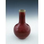 A Chinese monochrome baluster vase, sang de boeuf glaze, impressed Qianlong seal mark to base,