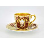 A Coalport jewelled and scene painted cup and saucer