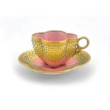A Coalport jewelled and gilded cup and saucer