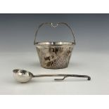 An Arts and Crafts silver sugar bowl and spoon, A E Jones, Birmingham 1924, planished conical pail