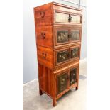 A Chinese marriage cabinet, late 19th/early 20th Century, in four sections with side handles, the