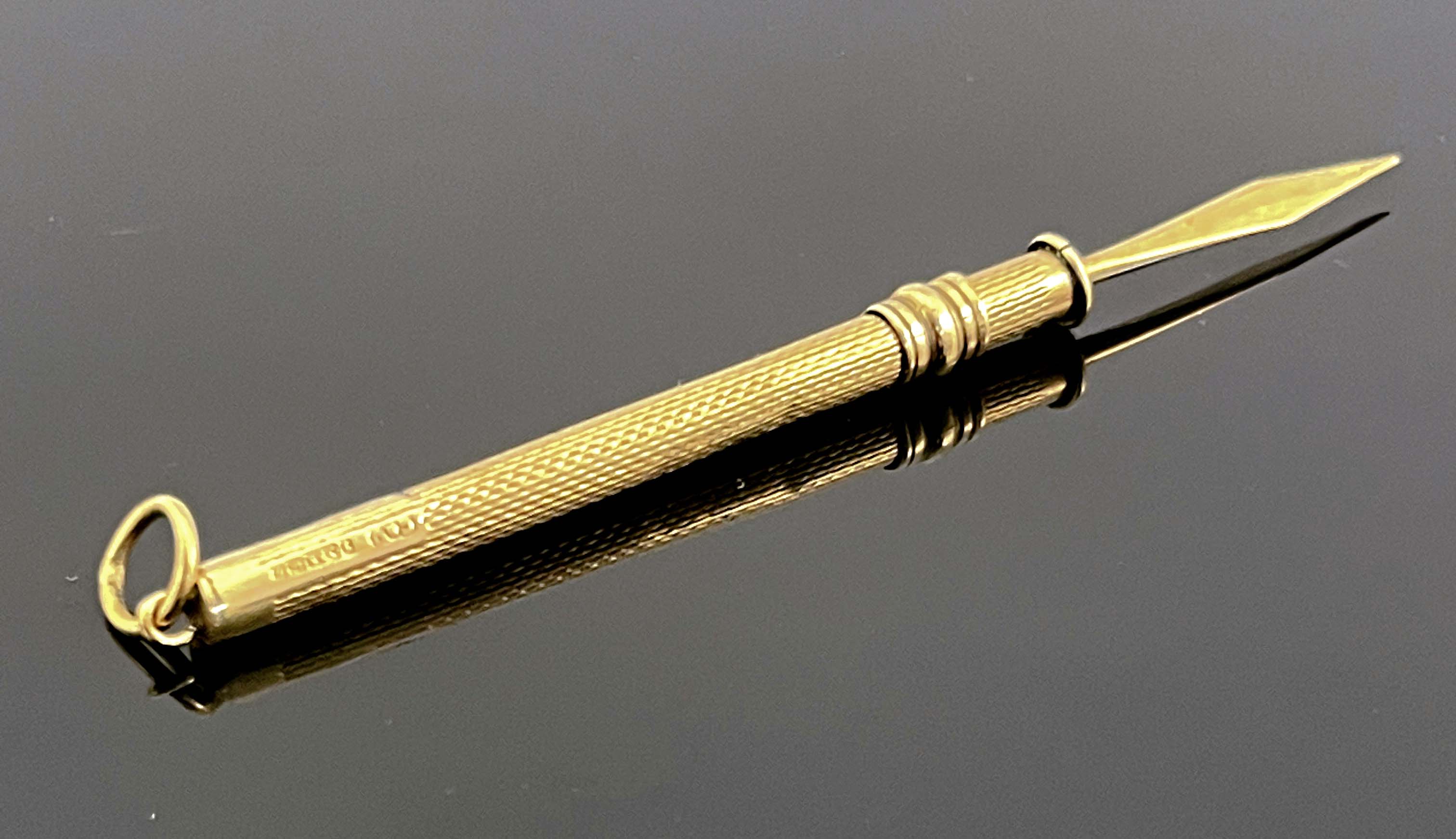 A 9ct gold propelling implement, Cohen & Charles, Birmingham, engine turned cylindrical form, 2.6g