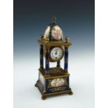 A late 19th Century Vienna clock, of architectural form incorporating a cupola, columns and