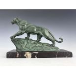 An Art Deco patinated art metal figure of a panther on a rock
