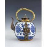 A Chinese blue and white porcelain teapot, of ovoid form with gilt metal loop handle, spout and