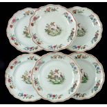 A set of six Chinese dinner plates, 18th Century, moulded silver shapes, famille rose decoration