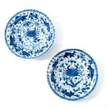 A pair of Chinese blue and white ribbed moulded saucers, kangxi, each painted with a central crab