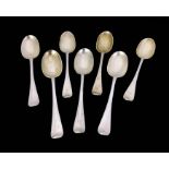A matched set of seven Victorian and George V silver dessert spoons, Josiah Williams and Sons, etc