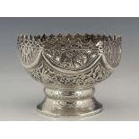 An Indian white metal reticulated pedestal bowl