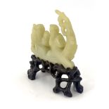 A Chinese pale jade model of a junk, containing a man with paddle and an elder holding a fish and