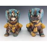 A large pair of Chinese tang glazed foo dogs, circa 1880, modelled sitting, one with paw resting