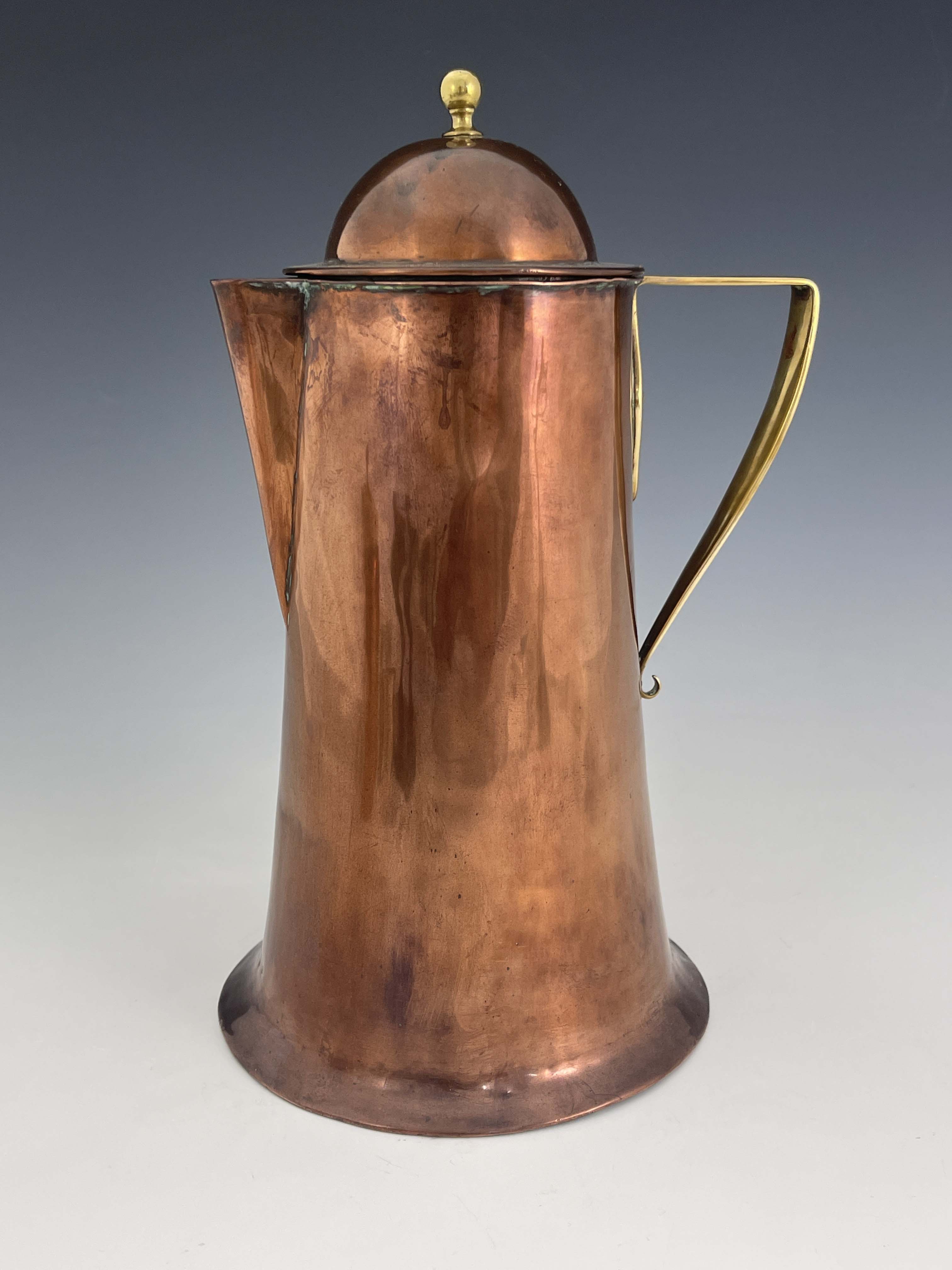 A S Dixon for Birmingham Guild of Handicraft, an Arts and Crafts copper and brass lidded jug, the