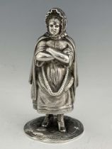 A Scottish silver pepper caster, W H & S Edinburgh 1926, in the form a lady standing with arms