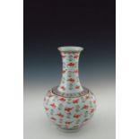 A 20th Century Chinese baluster vase, extended neck, ovoid body, the whole decorated with iron red