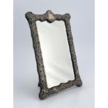 A Victorian silver framed mirror, Henry Matthews, Birmingham 1899, rectangular cartouche form, the