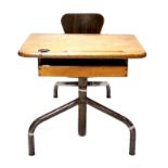 A French child's school desk, early 20th Century, oak top with ink pot hole, pen well and shelf