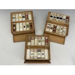 Three wooden boxes of laboratory glass specimen slides, written and printed labels to include