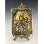 A Russian Icon, Moscow 1873, encased in embossed and chased silver gilt cover depicting Madonna