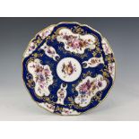A Worcester Flight Barr and Barr scale blue plate, circa 1820, painted with floral bouquets in