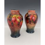 William Moorcroft, a near pair of flambe Leaf and Berry vases, circa 1930, of shouldered form,