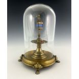A 19th century gilt brass reliquary under glass dome