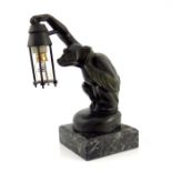 Max Le Verrier, a bronzed Boubou car mascot lamp